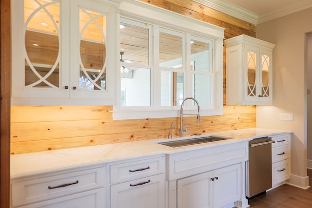 kitchen with white cabinetry, sink, crown molding, and light stone countertops