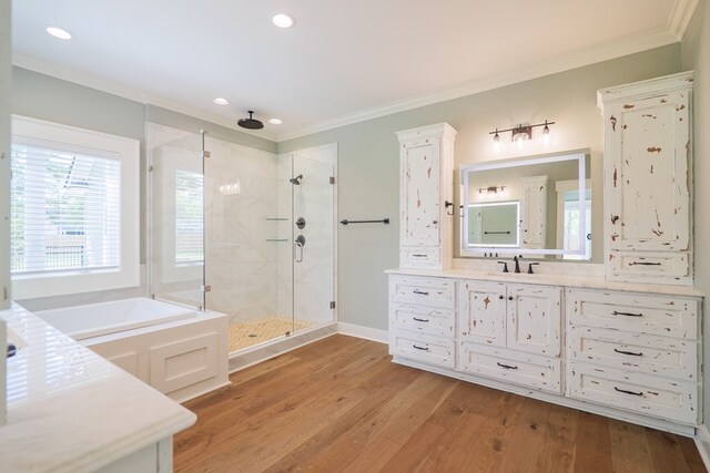 bathroom featuring ornamental molding, separate shower and tub, wood-type flooring, and vanity