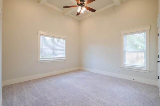 unfurnished room featuring coffered ceiling, ceiling fan, light colored carpet, and beamed ceiling