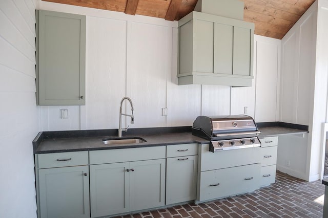 kitchen featuring sink and wooden ceiling