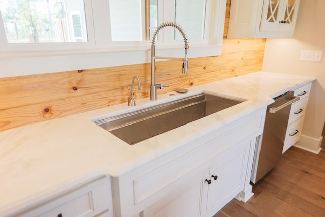 kitchen featuring sink, dishwasher, dark hardwood / wood-style floors, and white cabinets