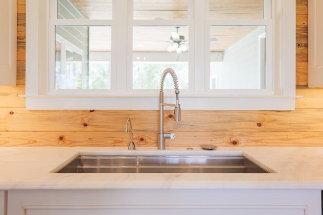 room details featuring white cabinetry and sink