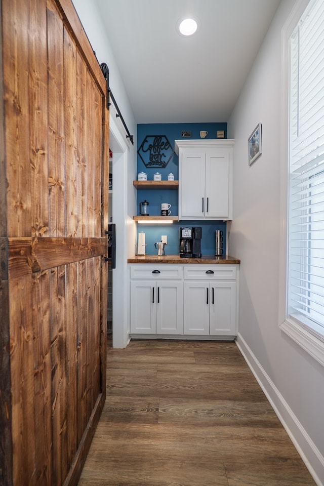 4310 Old Quitman Hwy, Valdosta, GA 31601 - bar area with a barn door, dark wood-style floors, and baseboards