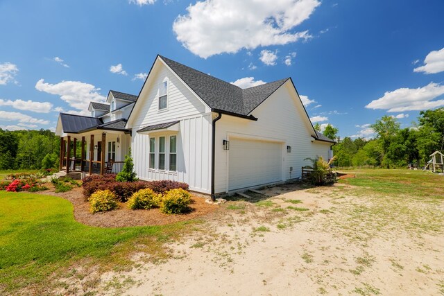 4310 Old Quitman Hwy, Valdosta, GA 31601 - view of home's exterior with board and batten siding, a standing seam roof, metal roof, an attached garage, and roof with shingles