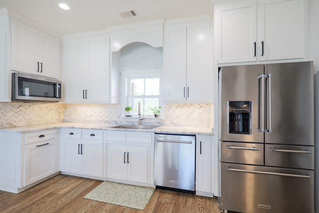 4310 Old Quitman Hwy, Valdosta, GA 31601 - kitchen with stainless steel appliances, a sink, white cabinetry, light wood finished floors, and recessed lighting