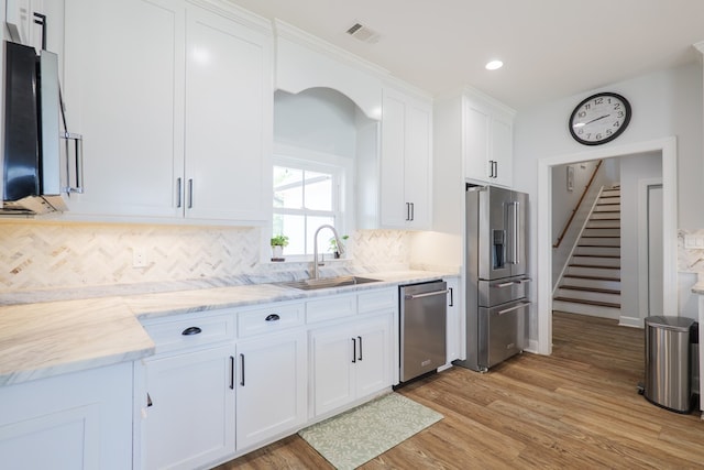 4310 Old Quitman Hwy, Valdosta, GA 31601 - kitchen featuring appliances with stainless steel finishes, a sink, white cabinetry, light wood finished floors, and recessed lighting