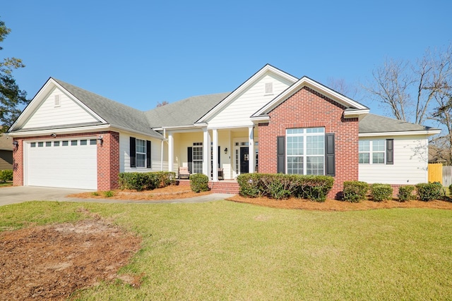 view of front of property with a porch, a garage, and a front lawn