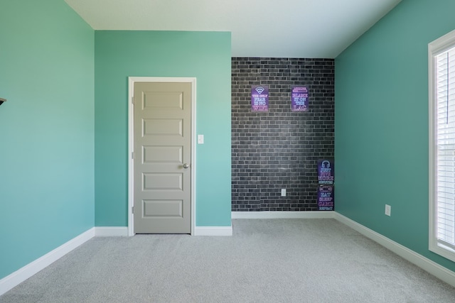 carpeted empty room with baseboards and a healthy amount of sunlight