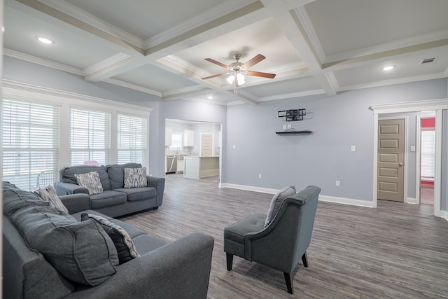 living room featuring a wealth of natural light, beam ceiling, baseboards, and ceiling fan