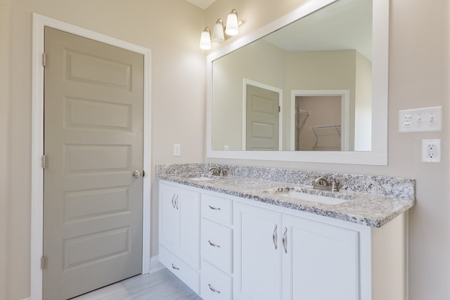 bathroom featuring double vanity and a sink