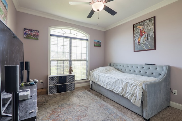 bedroom with carpet, ceiling fan, and ornamental molding