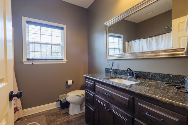 bathroom featuring hardwood / wood-style flooring, vanity, and toilet