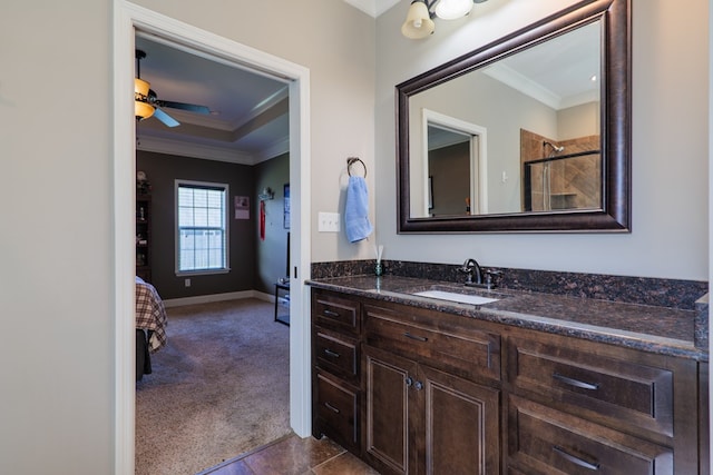 bathroom with ceiling fan, a shower, ornamental molding, and vanity