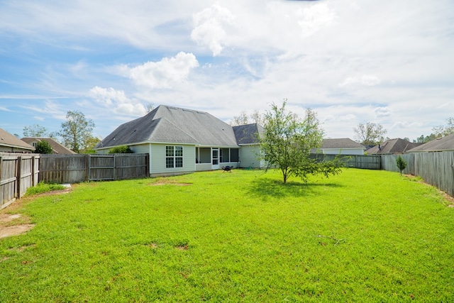 back of house featuring a lawn