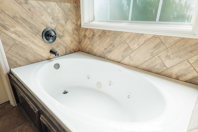 bathroom featuring a tub and a wealth of natural light