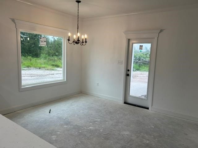 empty room featuring an inviting chandelier, baseboards, and unfinished concrete flooring