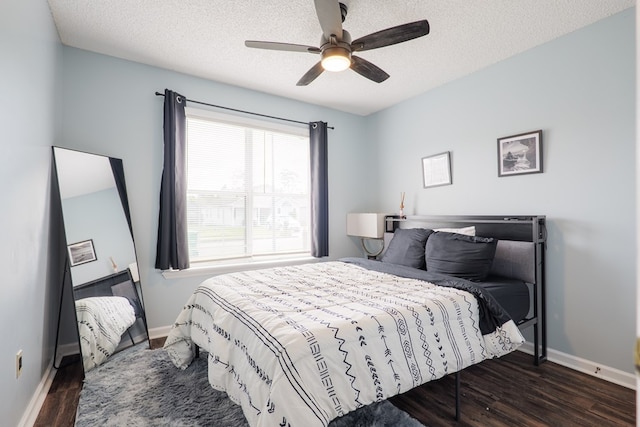 bedroom with a ceiling fan, wood finished floors, baseboards, and a textured ceiling