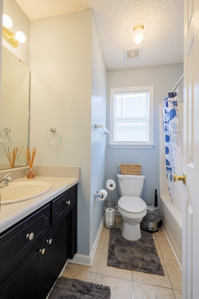 bathroom with vanity, visible vents, tile patterned flooring, a textured ceiling, and toilet