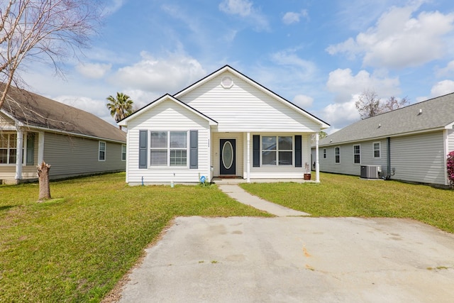 bungalow-style home featuring cooling unit and a front yard