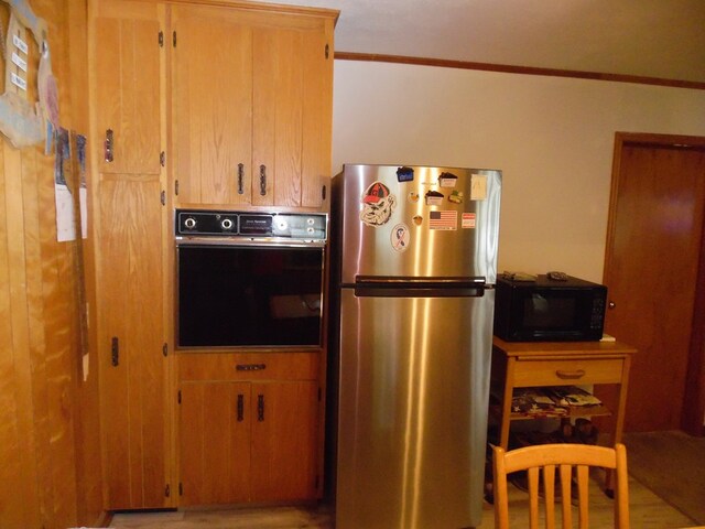 kitchen featuring crown molding and black appliances