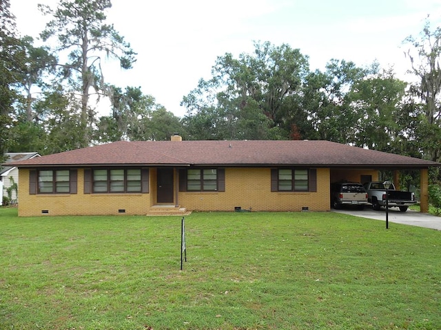 ranch-style home featuring a carport and a front yard