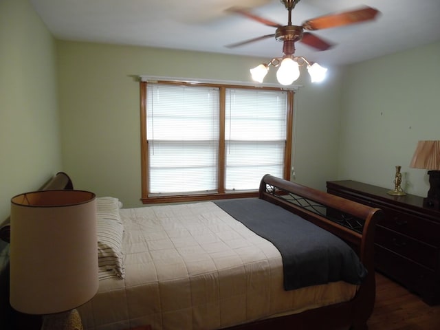 bedroom with ceiling fan and wood-type flooring