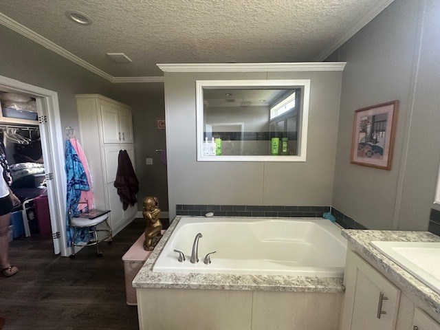 35 Tyler Rd, Naylor, GA 31641 - full bath featuring vanity, a bath, wood finished floors, a textured ceiling, and crown molding