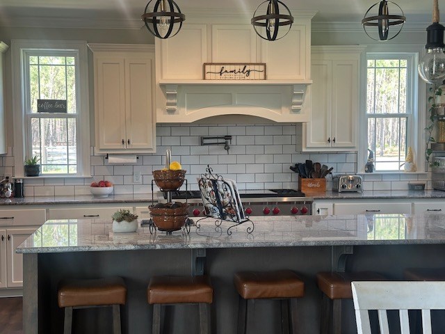 35 Tyler Rd, Naylor, GA 31641 - kitchen featuring a breakfast bar, white cabinets, ornamental molding, and tasteful backsplash
