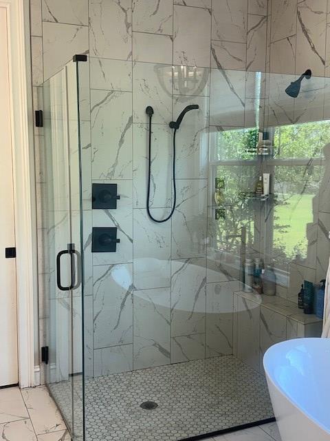 35 Tyler Rd, Naylor, GA 31641 - full bathroom with marble look tile flooring, a marble finish shower, and a freestanding tub