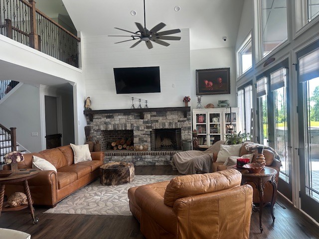 35 Tyler Rd, Naylor, GA 31641 - living area with a high ceiling, ceiling fan, a fireplace, dark wood-style flooring, and stairs