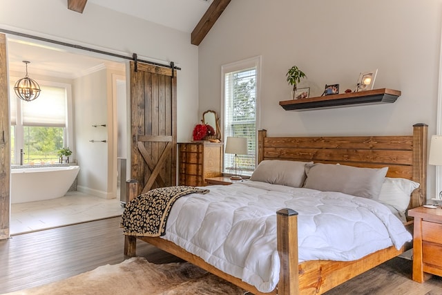 35 Tyler Rd, Naylor, GA 31641 - bedroom with wood finished floors, a barn door, baseboards, and a chandelier