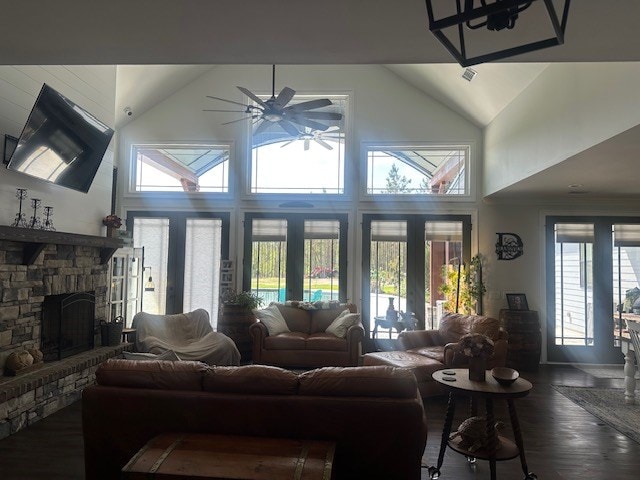 35 Tyler Rd, Naylor, GA 31641 - living area with ceiling fan, dark wood-type flooring, high vaulted ceiling, a stone fireplace, and french doors
