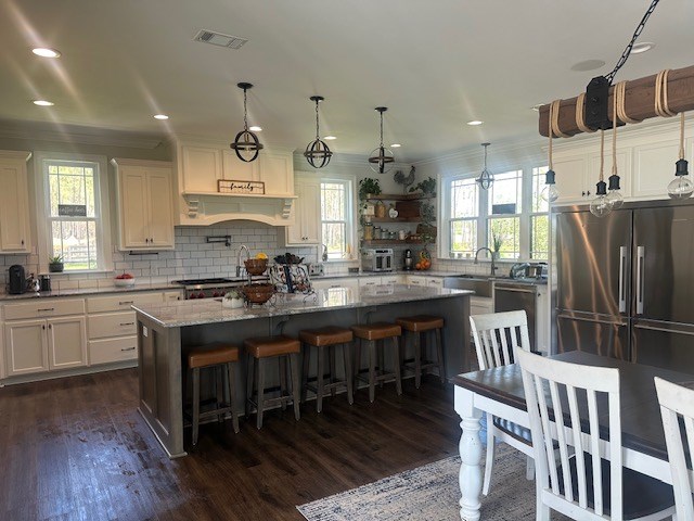 35 Tyler Rd, Naylor, GA 31641 - kitchen featuring backsplash, white cabinetry, dark wood-style floors, a center island, and stainless steel appliances