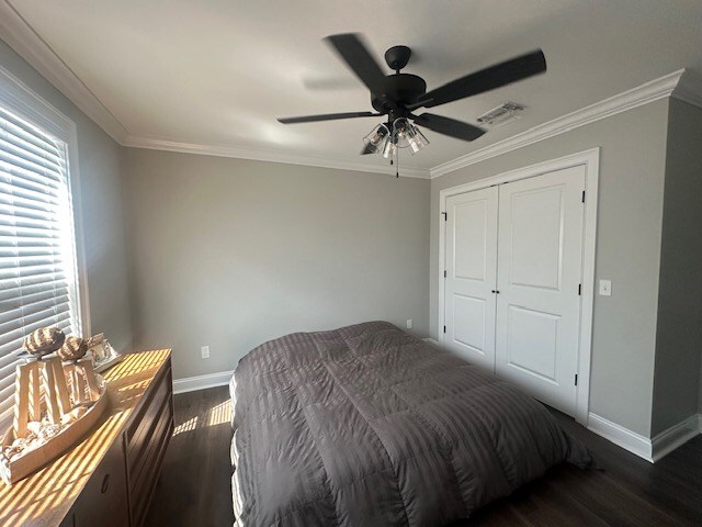 35 Tyler Rd, Naylor, GA 31641 - bedroom featuring baseboards, dark wood-style flooring, ornamental molding, a closet, and a ceiling fan