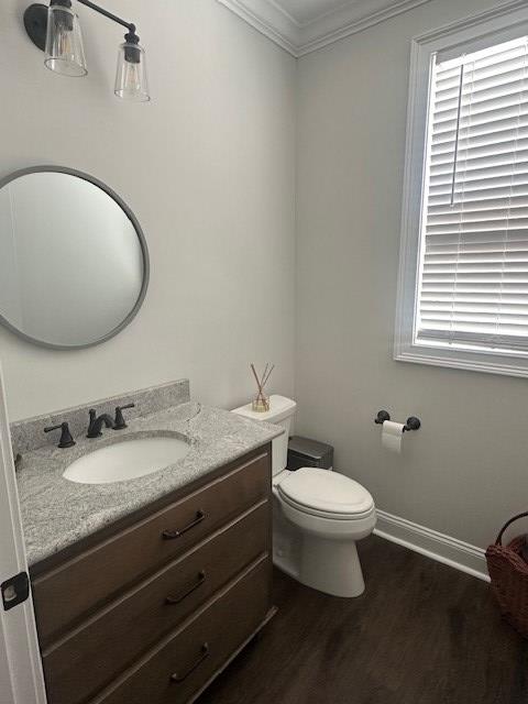 35 Tyler Rd, Naylor, GA 31641 - half bathroom with ornamental molding, wood finished floors, vanity, toilet, and baseboards