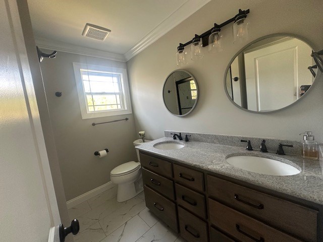 35 Tyler Rd, Naylor, GA 31641 - bathroom featuring double vanity, marble finish flooring, crown molding, toilet, and baseboards