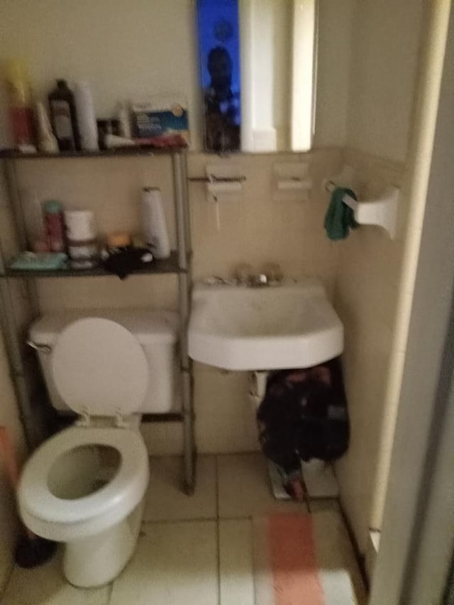 bathroom with tile patterned floors, toilet, and sink