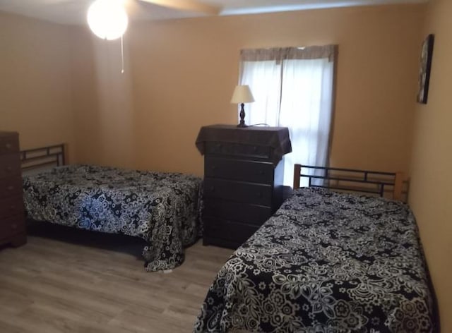 bedroom with ceiling fan and light hardwood / wood-style floors