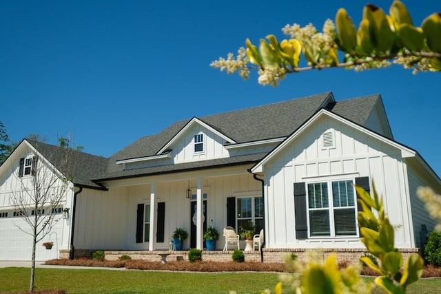 4809 Brown Cat Cir, Hahira, GA 31632 - modern farmhouse featuring board and batten siding, covered porch, an attached garage, and a shingled roof