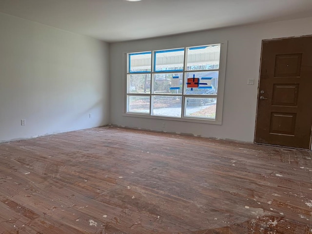 unfurnished room with wood finished floors