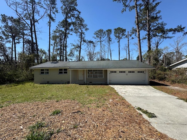 ranch-style home with metal roof, a front lawn, a garage, and driveway