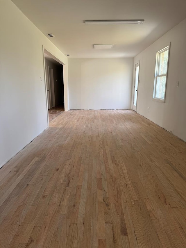 empty room with visible vents and wood finished floors