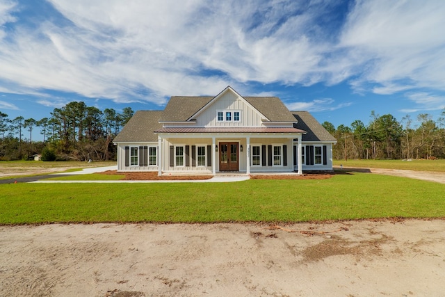 3376 Bemiss Knights Academy Rd, Valdosta, GA 31605 - view of front facade with board and batten siding, a front yard, and covered porch