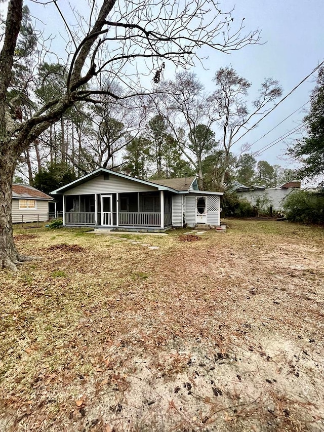 back of house featuring a sunroom