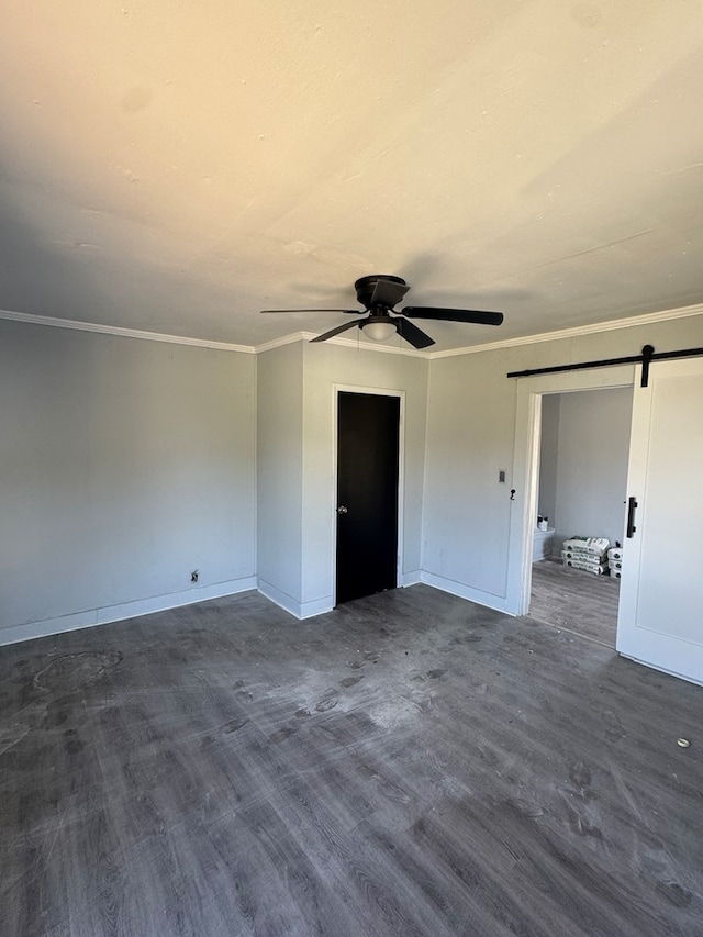 218 Teddy St, Thomasville, GA 31792 - unfurnished bedroom with ceiling fan, baseboards, a barn door, ornamental molding, and dark wood-style floors