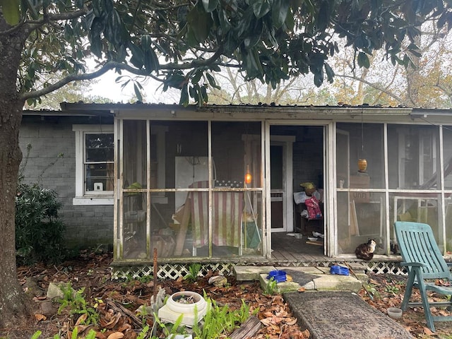 back of house featuring a sunroom