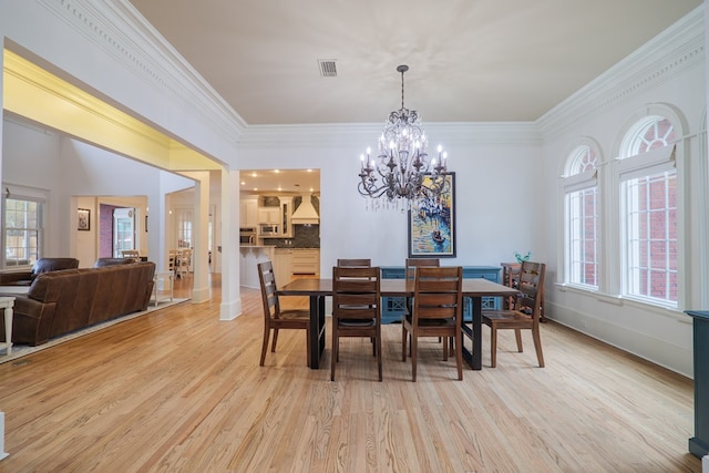 dining area with ornamental molding, plenty of natural light, and light wood-type flooring