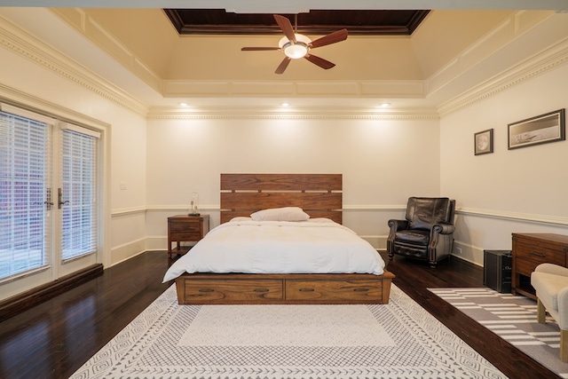 bedroom with crown molding, dark hardwood / wood-style flooring, a raised ceiling, and access to exterior