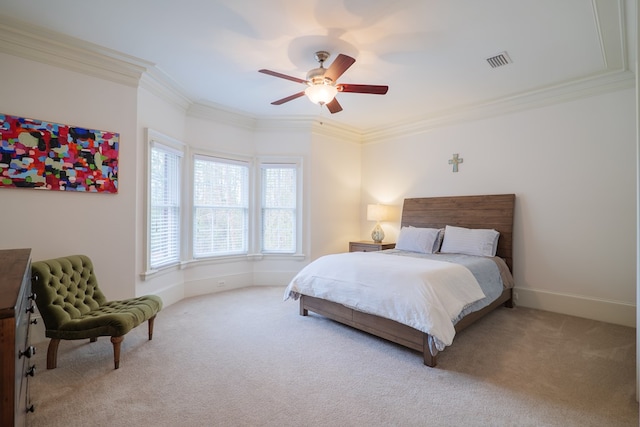 carpeted bedroom featuring crown molding and ceiling fan