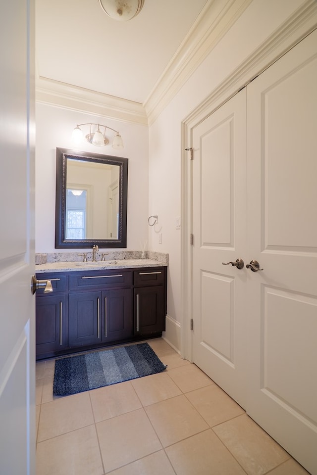 bathroom with tile patterned floors, ornamental molding, and vanity